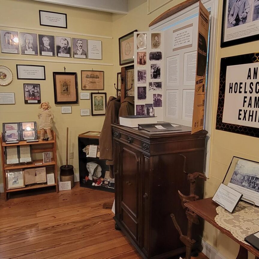 A room with many pictures and other items on the wall.