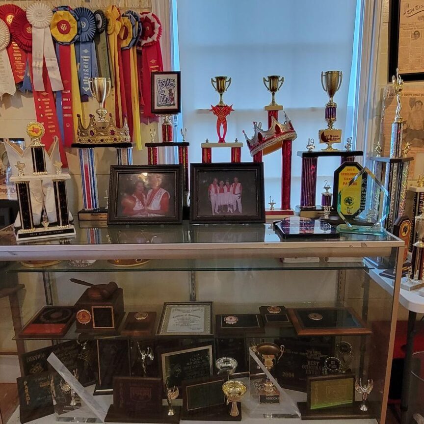 A display case with trophies and awards on it.