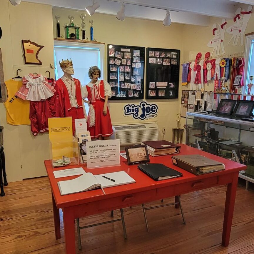 A red table with papers and other items on it.